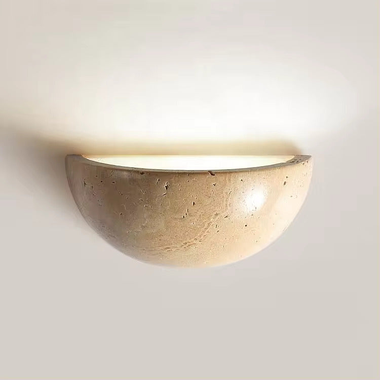 Sparkling Stella half-dome wall light by Lise Luxury illuminating a bedroom wall with a warm glow.