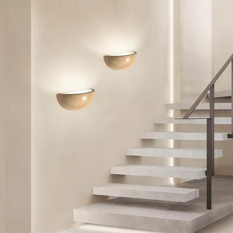 Sparkling Stella half-dome wall light by Lise Luxury illuminating a bedroom wall with a warm glow.