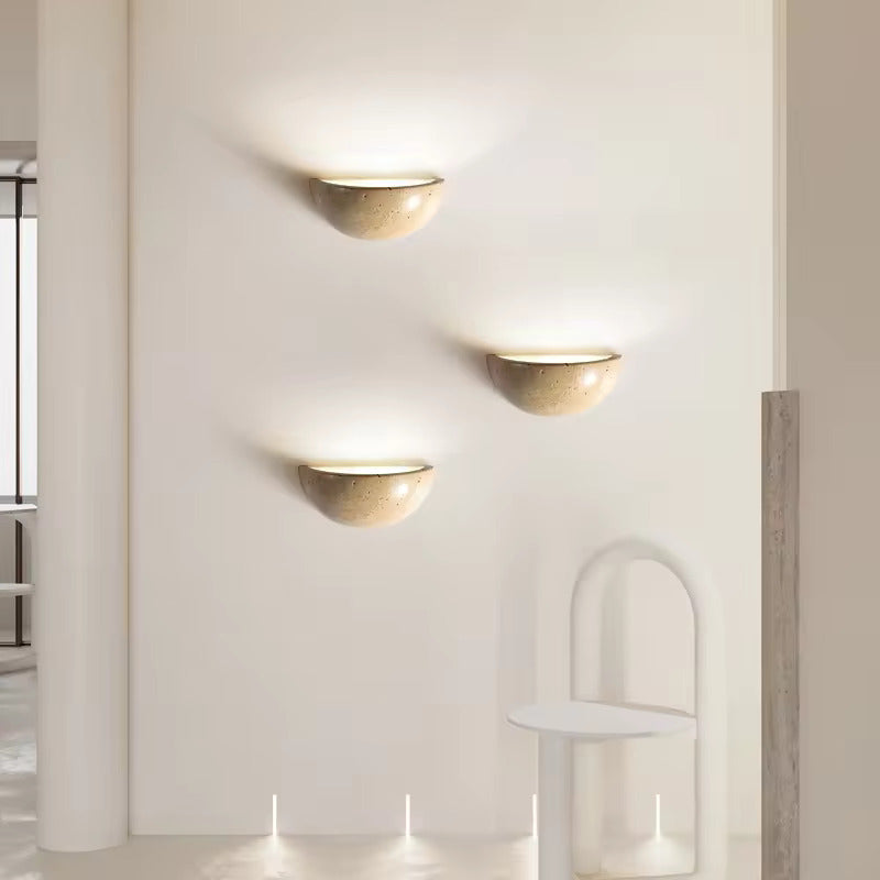 Sparkling Stella half-dome wall light by Lise Luxury illuminating a bedroom wall with a warm glow.
