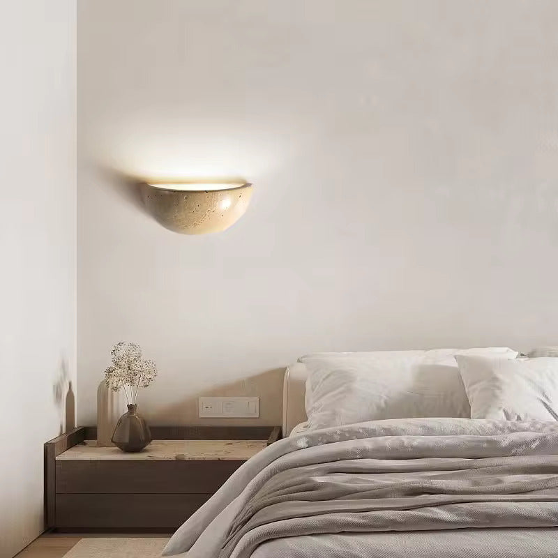 Sparkling Stella half-dome wall light by Lise Luxury illuminating a bedroom wall with a warm glow.