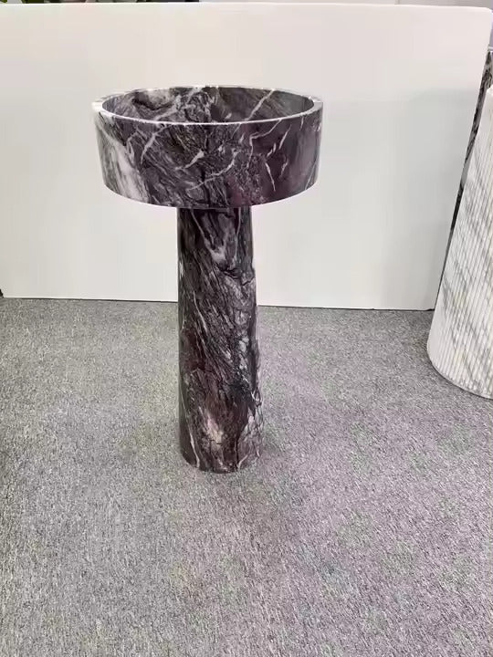A round Mushroom - Standing Marble Basin Sink from Lise Luxury with a dark veined pattern exudes elegance and luxury.