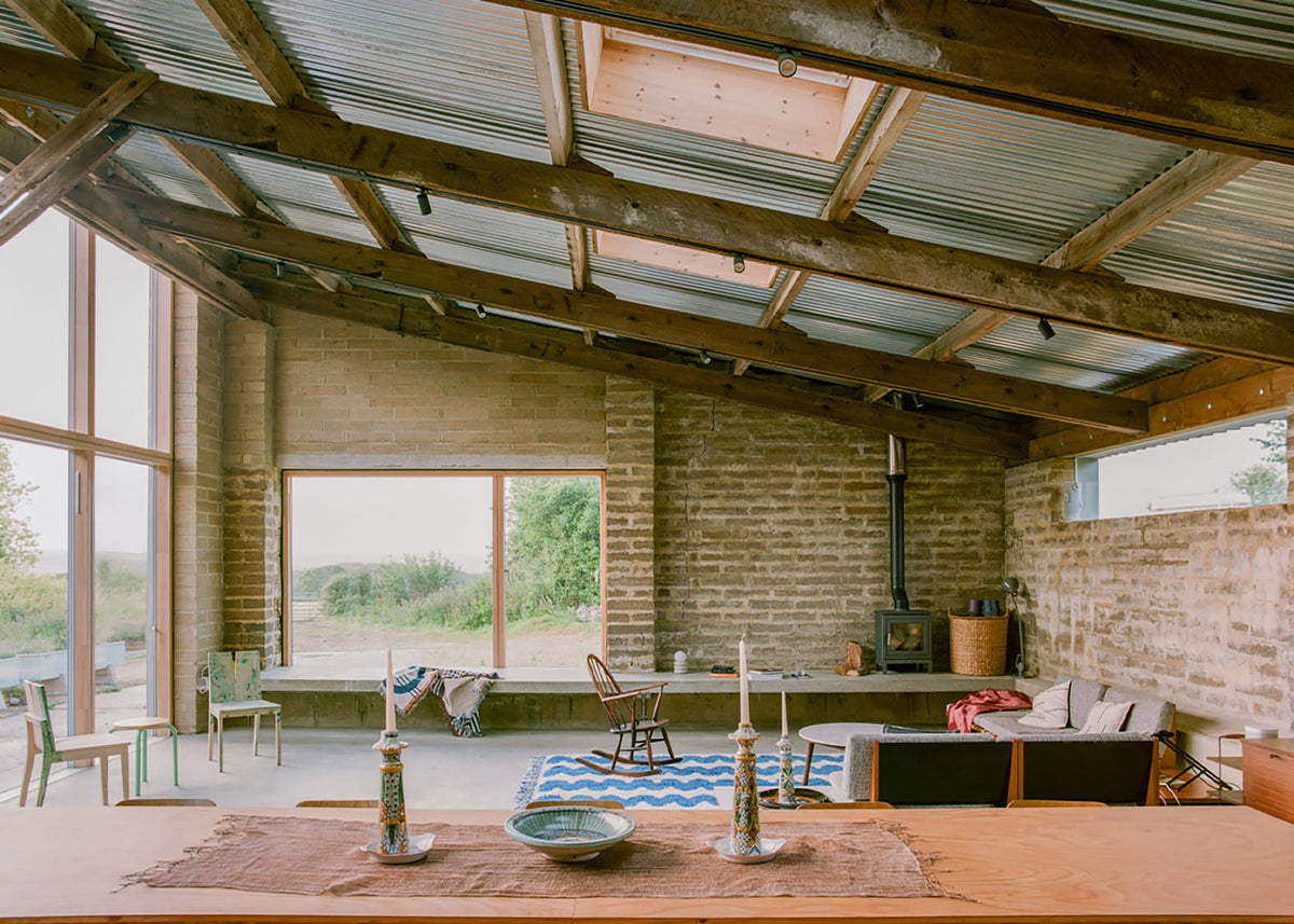 Exposed masonry, roof timbers and corrugated metal frame South Barn’s living space.