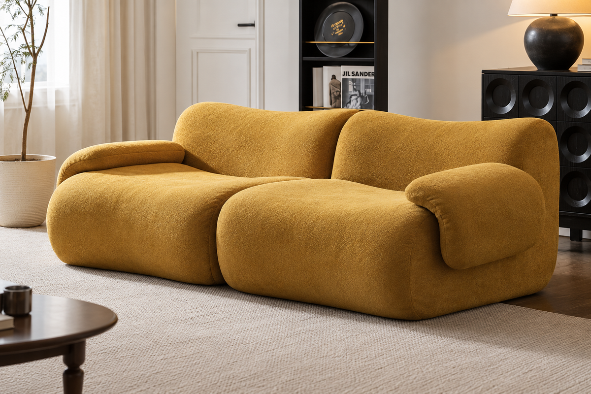 A modern modular sofa upholstered in a textured mustard yellow fabric, styled in a contemporary living room setting.