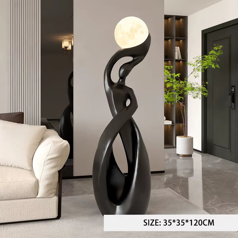 Abstract black floor lamp with a sculptural curved form and a glowing moon globe on top, shown in a modern living room setting. A size label at the bottom reads 35*35*120CM.