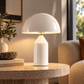 [color: white] White mushroom lamp on a round marble table 