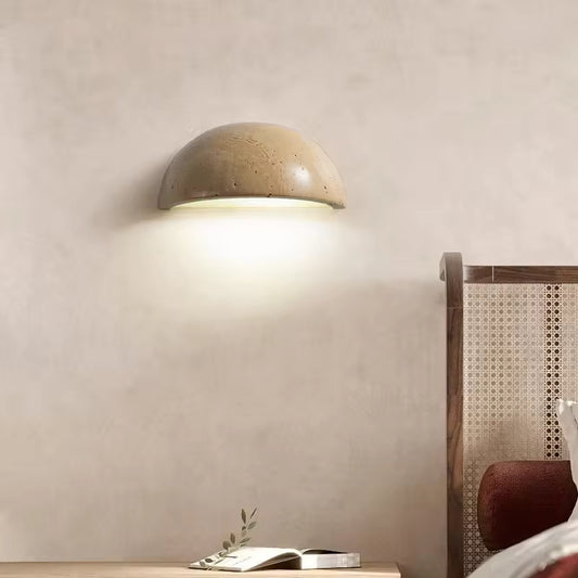 Sparkling Stella half-dome wall light by Lise Luxury illuminating a bedroom wall with a warm glow.