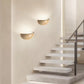 Sparkling Stella half-dome wall light by Lise Luxury illuminating a bedroom wall with a warm glow.