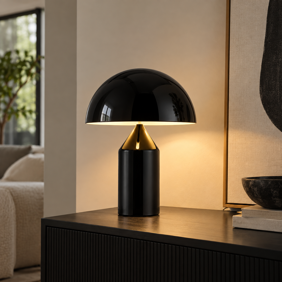 [color: black] A modern mushroom-shaped table lamp with a glossy black dome shade and cylindrical base, illuminated with a warm glow, set on a dark wooden console table in a stylishly decorated room.