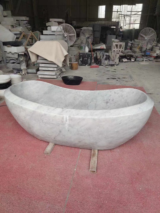A large Lavish Marble Bath Tub of industrial design in a workshop setting by Lise Luxury.