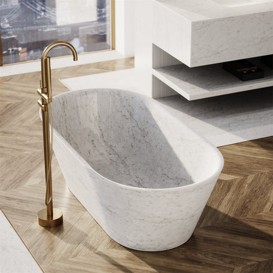 Luxurious Lise Luxury marble bathtub with a brass floor-mounted faucet in a minimalistic, modern bathroom setting.