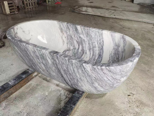 Elegantly designed Excellent Marble Bath Tub by Lise Luxury with natural stone patterns on display, embodying luxury.