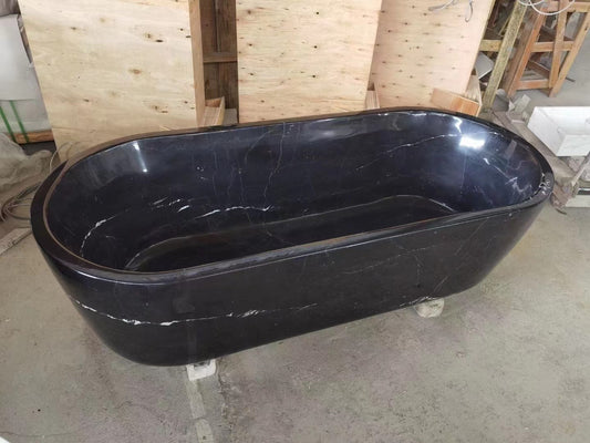 A Black Panther Marble Bath Tub by Lise Luxury in a workshop setting.