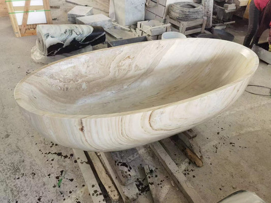 An unfinished Lise Luxury Magnificent Marble Bath Tub in a workshop setting.