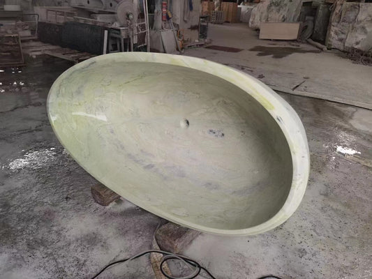 A Lise Luxury Light Green Marble Bath Tub mold inside a workshop.