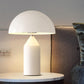 [color: white] White table lamp on a round marble table with a blurred background