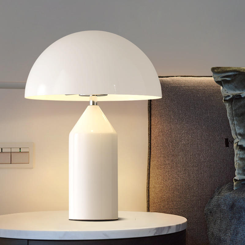[color: white] White table lamp on a round marble table with a blurred background