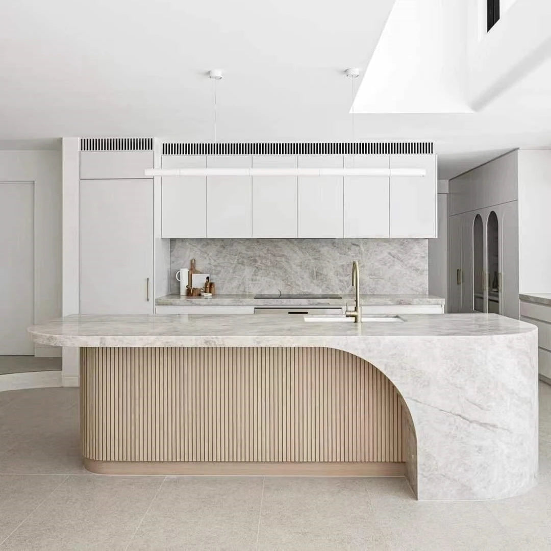 Sculptural pale natural stone kitchen island