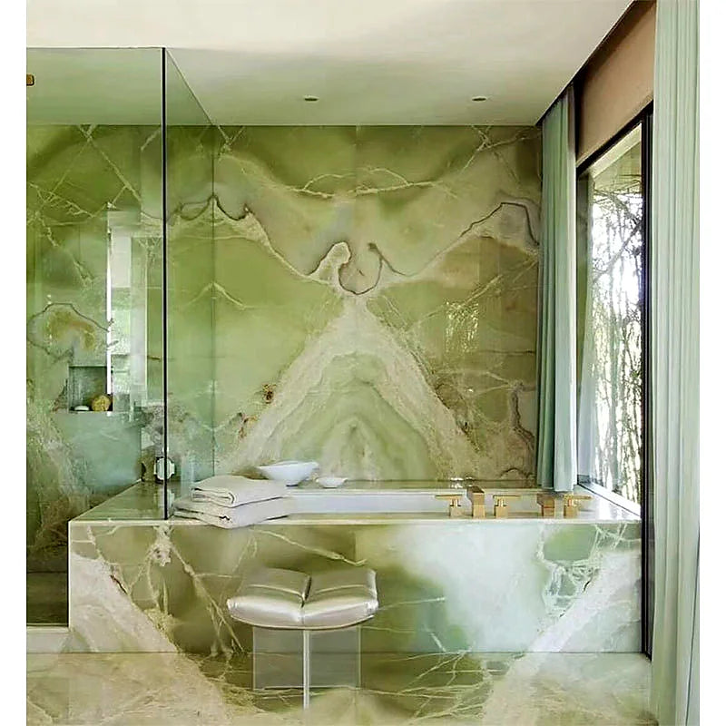 Green bookmatched natural stone bathroom with statement marble surfaces
