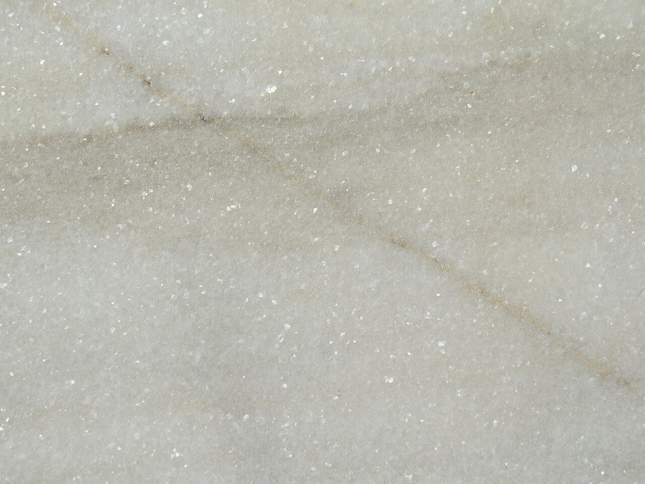Photographed pale stone surface with diagonal veining