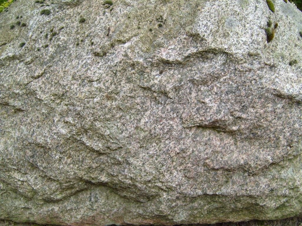 Photographed grey-green stone surface with textured mineral variation