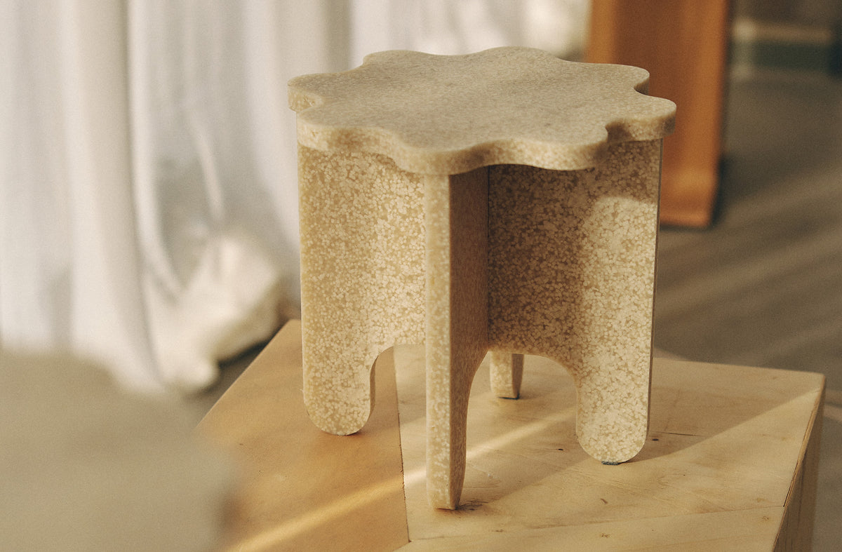 MOZI Studio biopolymer stool displayed on a wooden plinth