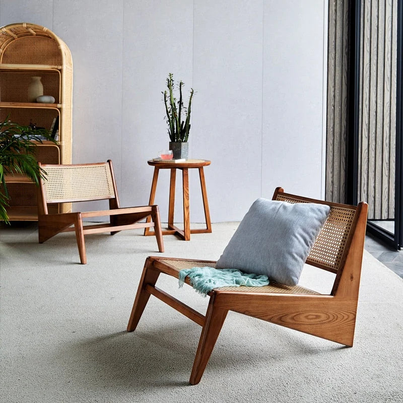 Designer lounge chair in natural wood and woven cane