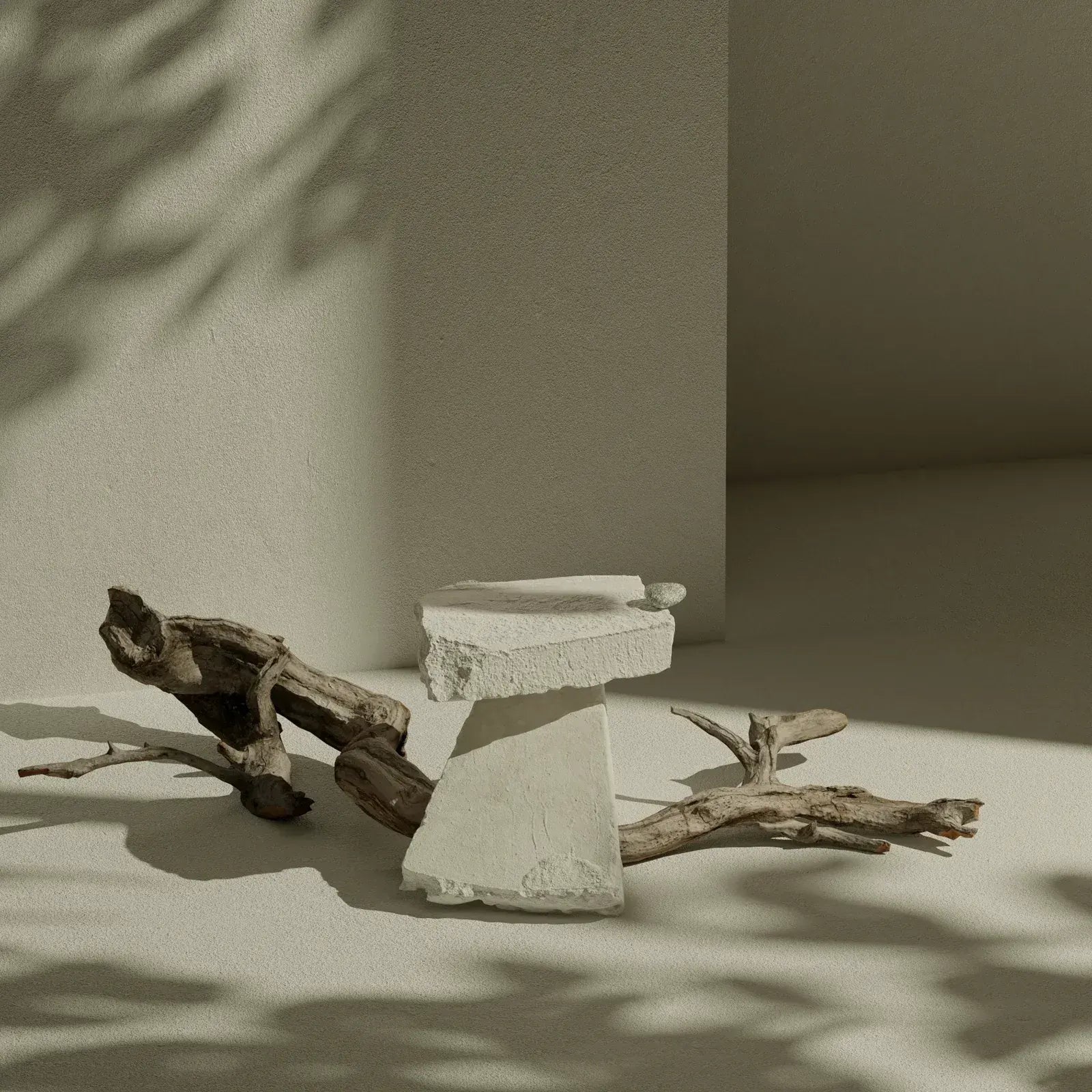 Sculptural stone forms and expressive natural light in an artistic editorial composition